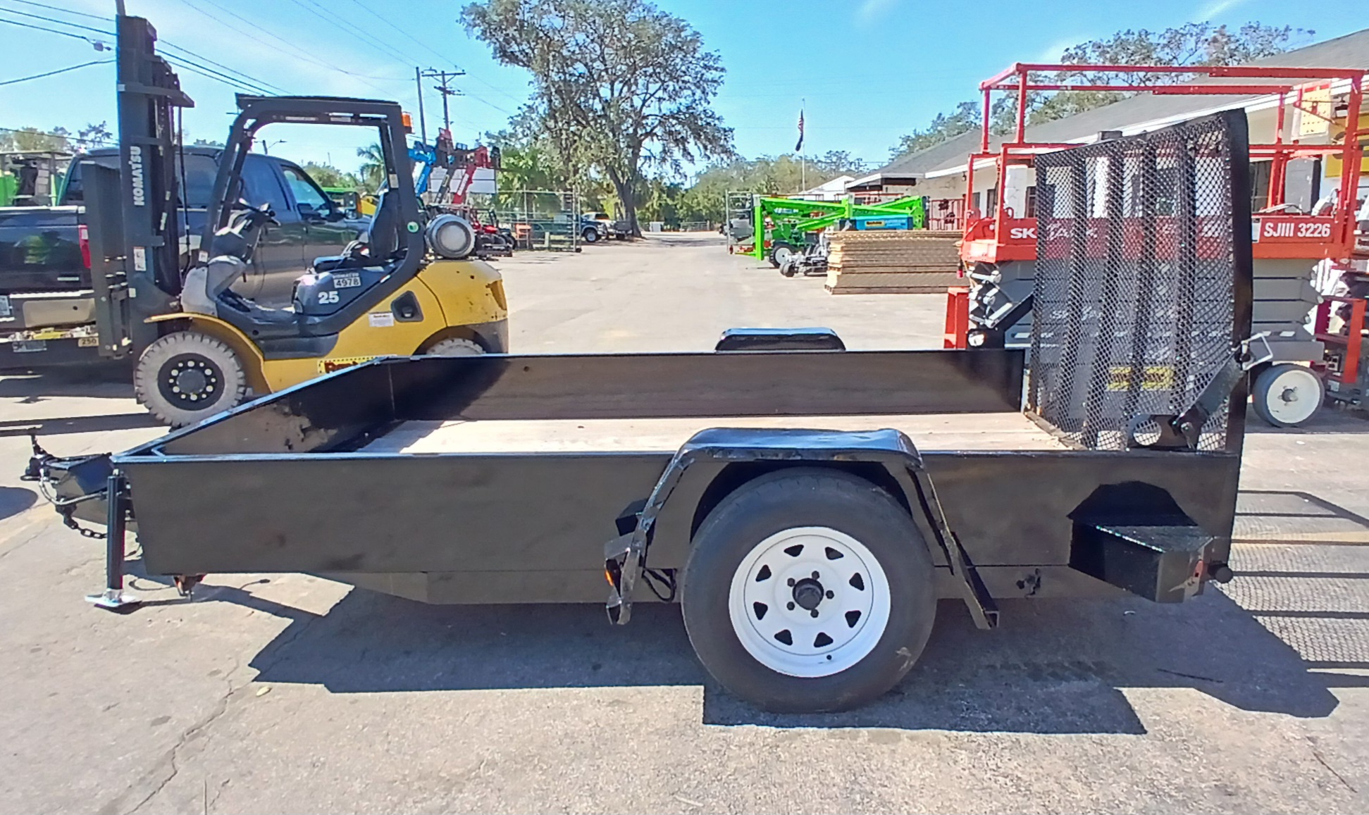 Skilled trailer rental specialist inspecting hitch setup and load balance before departure