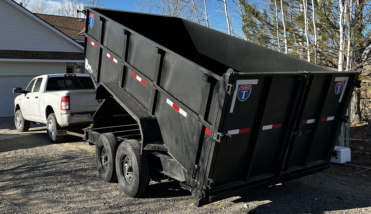 Skilled rental professional inspecting trailer connection and load balance for a local hauling job