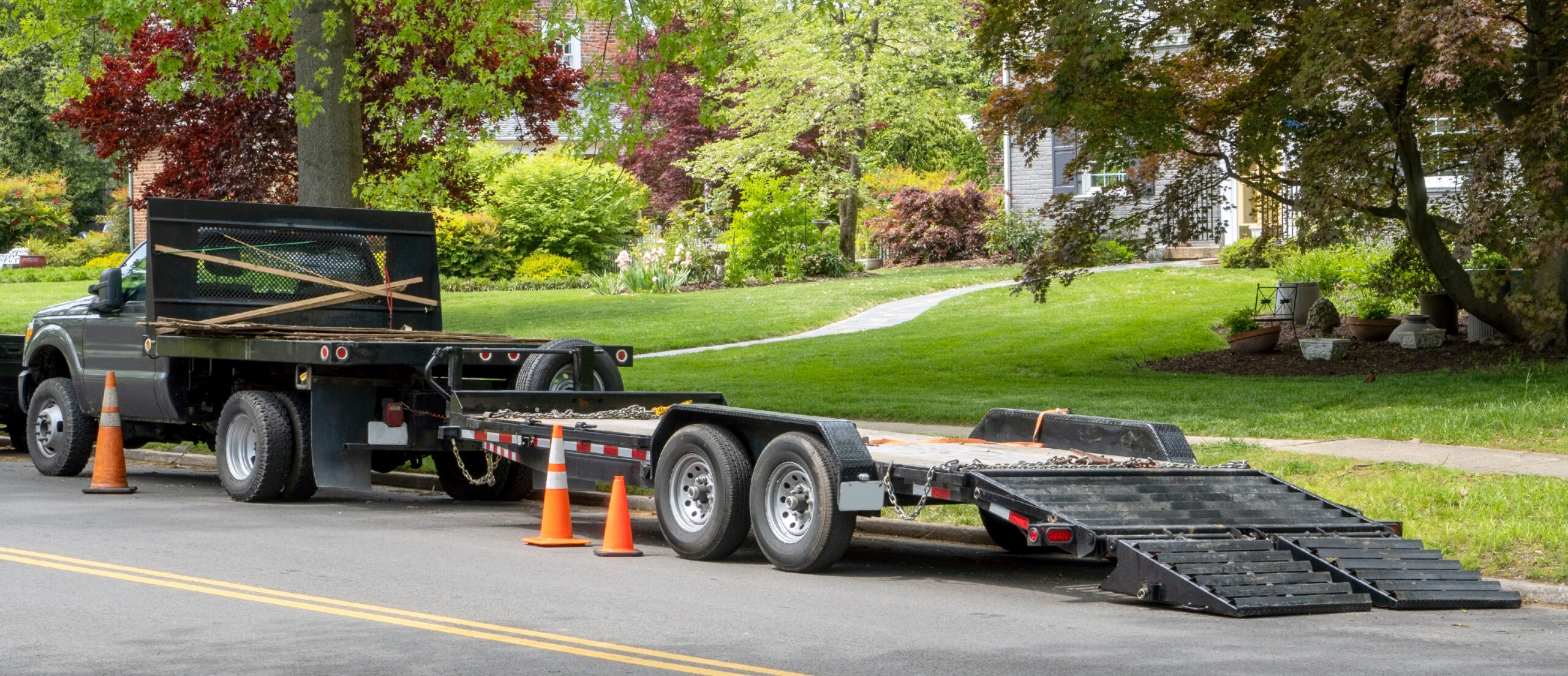 Experienced staff member checking trailer connections and load balance before a local rental departure